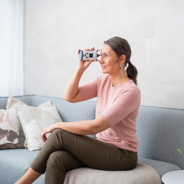 Woman comfortably using the iCare HOME2 at home